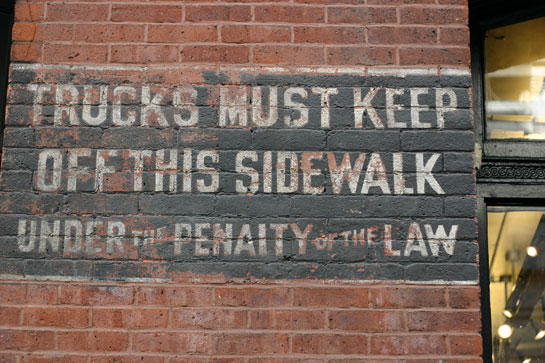 faded text on brick wall