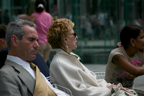People relaxing near the Apple Store, 5th Ave, NYC